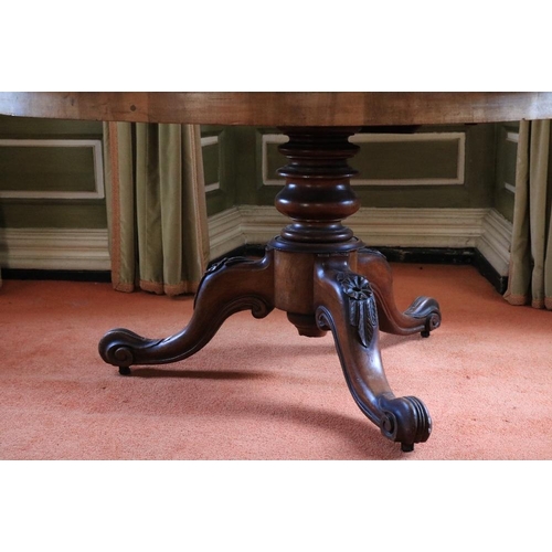 402 - A Victorian circular walnut Breakfast Table, on a turned stem on a tripod with scroll legs, 52