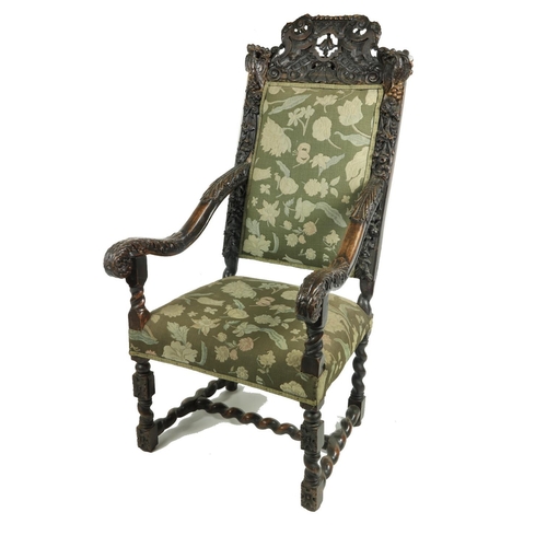 555 - An early 19th Century Cromwellian style walnut high back Armchair, the shell and leaf crested top fl... 