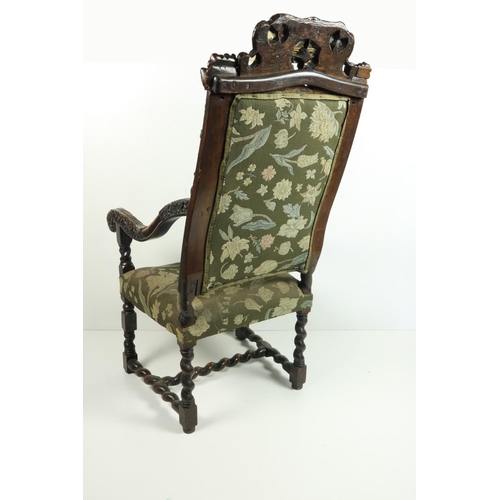 555 - An early 19th Century Cromwellian style walnut high back Armchair, the shell and leaf crested top fl... 