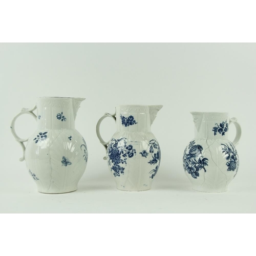 83 - A set of three 18th Century blue and white Worcester leaf moulded Mask Jugs, of graduating form, dec... 