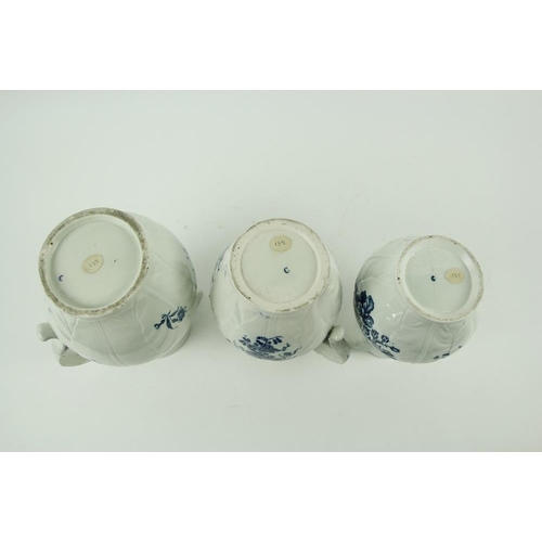 83 - A set of three 18th Century blue and white Worcester leaf moulded Mask Jugs, of graduating form, dec... 