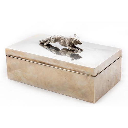 772 - A rectangular silver Cigarette Box, the hinged top surmounted with the figure of a running fox, Dubl... 