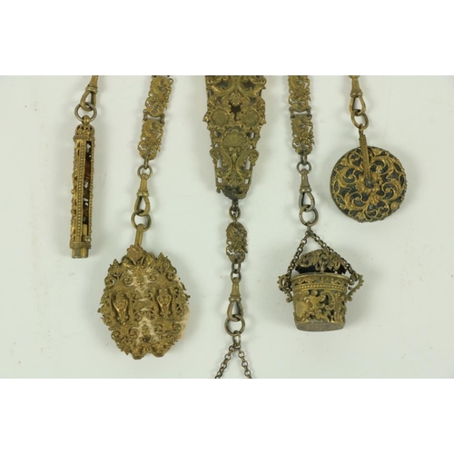 865 - A 19th Century gilt brass Chatelain, with five suspender chains, with pin cushion, a thimble holder,... 