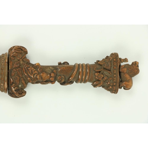 906 - A very rare Ottoman carved walnut Hunting Dagger, the hilt with lion and snake pommel, the grip with... 