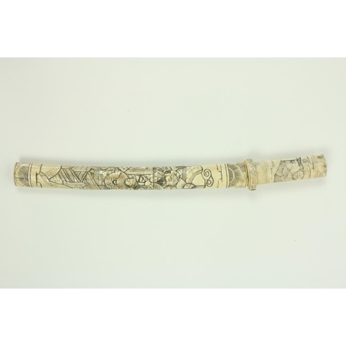 907 - A Japanese carved bone Tanto (Dagger), the scabbard and hilt carved with numerous figures, 17