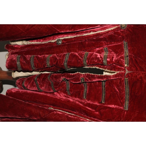 947 - A rare late 18th Century dark red velvet Gentleman's Jacket, lined with fur and felt, two flap over ... 