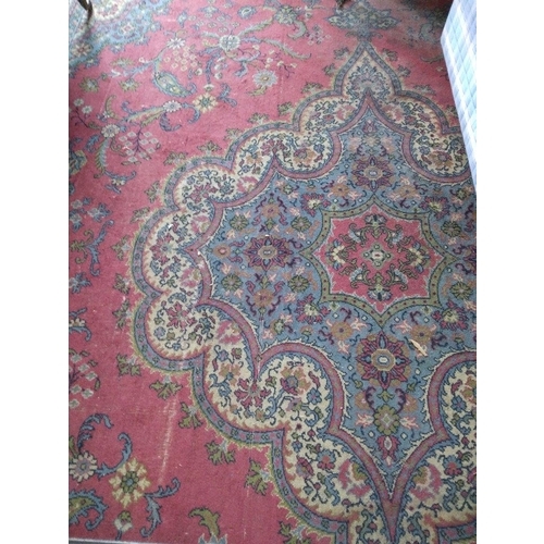 277 - An Oriental style machine made Carpet, with large centre medallion crimson ground and stylized flowe... 