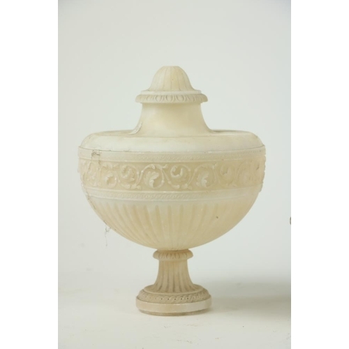 846 - A pair of late 19th Century Alabaster Urns and Covers, each with a band of carved scrolling foliage ... 