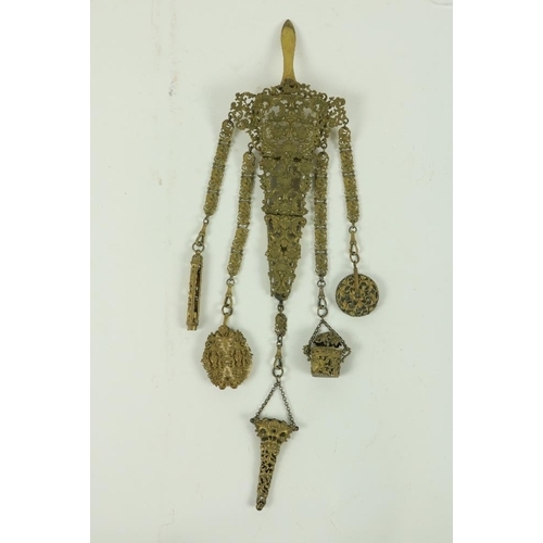 865 - A 19th Century gilt brass Chatelain, with five suspender chains, with pin cushion, a thimble holder,... 