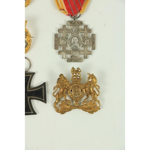 879 - Two British Army lion and unicorn Cap Badges, in gilt brass, a World War I German Iron Cross, dated ... 