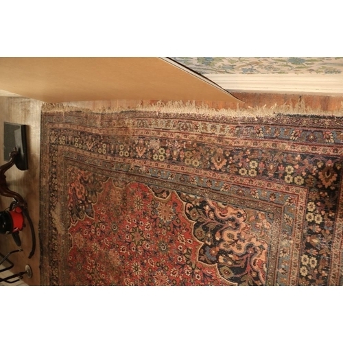 191 - A large antique Persian Carpet, with all over floral pattern and centre medallion panel of dark blue... 