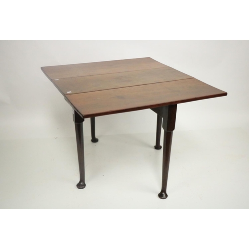 311 - An Irish mahogany drop leaf Table, 18th Century, with rectangular flaps on four tapering turned legs... 