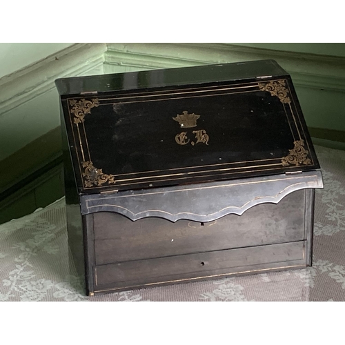 297 - A brass inlaid ebonised slope front Stationary Box, with inlaid brass coronet and monogram, 12