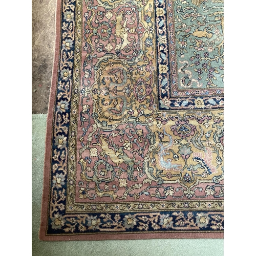 305 - A pair of Oriental style machine made lime ground Carpets, each with pink and ivory medallion centre... 