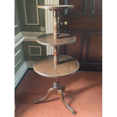 396 - A late Georgian period circular mahogany three tier Dumbwaiter, with turned pillar supports on a tri... 