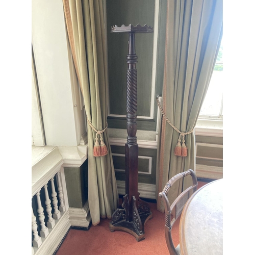 404 - A 19th Century mahogany Torchére, (adapted from a bedpost), on a half spiral reeded stem on a... 