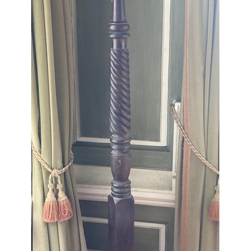 404 - A 19th Century mahogany Torchére, (adapted from a bedpost), on a half spiral reeded stem on a... 