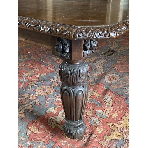 577 - A Victorian period Cromwellian style extending Dining Table, with three spare leaves, the carved edg... 