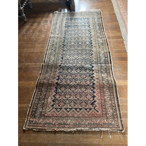 578 - An Afghan Rug, with rows of octagons on a faded ivory field with a multi banded border,approx. 10'7