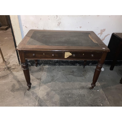 603 - A Victorian mahogany veneered Ladies Writing Table, with rectangular moulded top on octagonal taperi... 