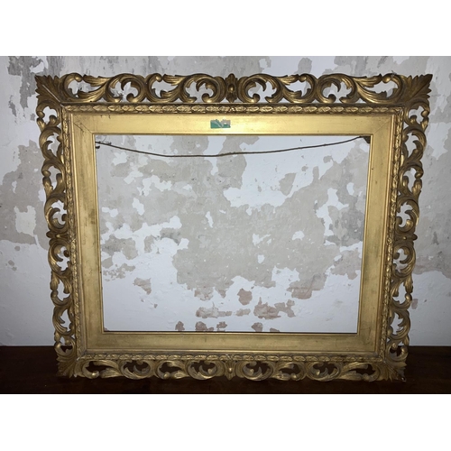 613 - A rectangular Florentine carved giltwood Frame, with scrolling foliage, to fit canvas 22