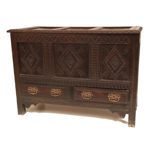 627 - An early 18th Century oak Coffer, the top with three recessed panels, and a moulded rim, above a fro... 