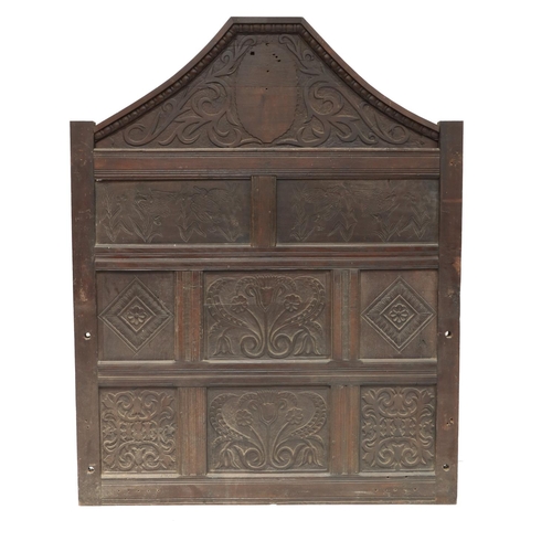 630 - A 17th Century and later carved oak Overmantel Panel, the shaped capital with shield centre above ei... 