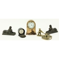 A pair of small bronze Desk Figures, modelled as Sphinx, a small heavy brass Desk Clock, the dial si... 