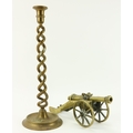 A heavy brass Desk Cannon, with engraved decoration; and a tall twisted brass Candlestick, 40cms (15... 