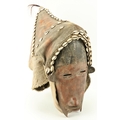 A rare and unusual early 20th Century West African Dan Mask, with slit eyes and fiber headdress cove... 