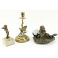 A small attractive Art Nouveau bronze Desk Oil Lamp, modelled with a cherub on a leaf, with glass oi... 