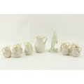 A First period Belleek Jug, nine other small Belleek Jugs, and another item. A lot. (11)... 