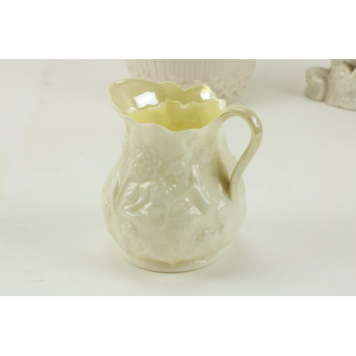30 - A First period Belleek Jug, nine other small Belleek Jugs, and another item. A lot. (11)... 