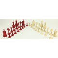 An attractive late 19th Century carved ivory Chess Set, (32 pieces complete) with half stained red, ... 