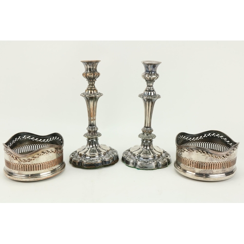 69 - A pair of large plated Wine Coasters, with decorated pierced sides; and a pair of silver plated Cand... 