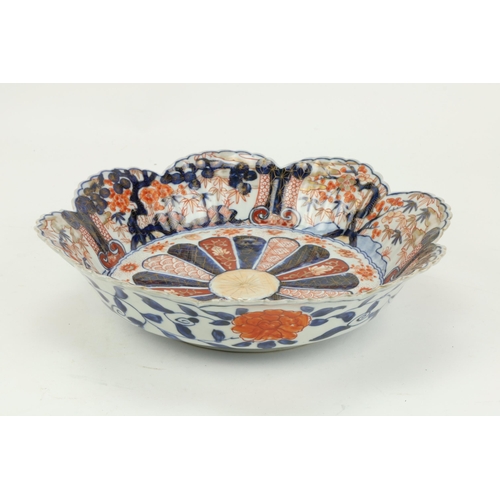 79 - An unusual Imari Bowl, with shaped serrated rim and with fan shaped center, decorated with flowers, ... 