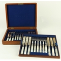 A cased set of 24 mother-o-pearl handled engraved Fruit Knives and Forks, in oak presentation box. (... 