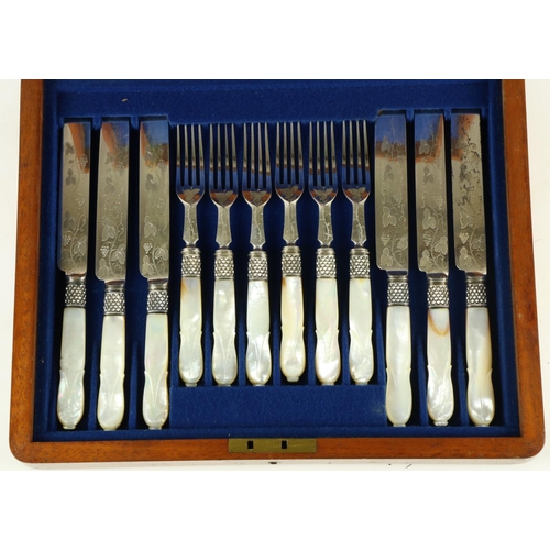 242 - A cased set of 24 mother-o-pearl handled engraved Fruit Knives and Forks, in oak presentation box. (... 