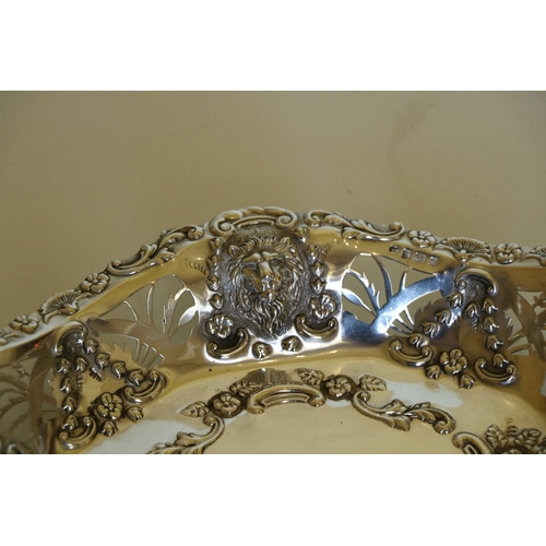 664 - An attractive pierced and embossed oval silver Bon Bon Dish, decorated with lion masks, and floral g... 