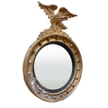 A Regency period gilt convex Wall Mirror, with carved eagle crest on a ball moulded frame, 31