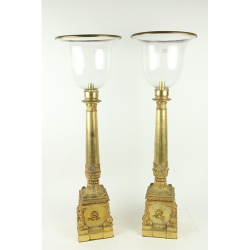 130 - An attractive pair of gilt and cast brass tall Candle Lanterns, each with a glass shade on a reeded ... 