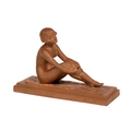 An Art Deco Figure, of a seated nude girl on rectangular stepped base, signed Pozzi, 14