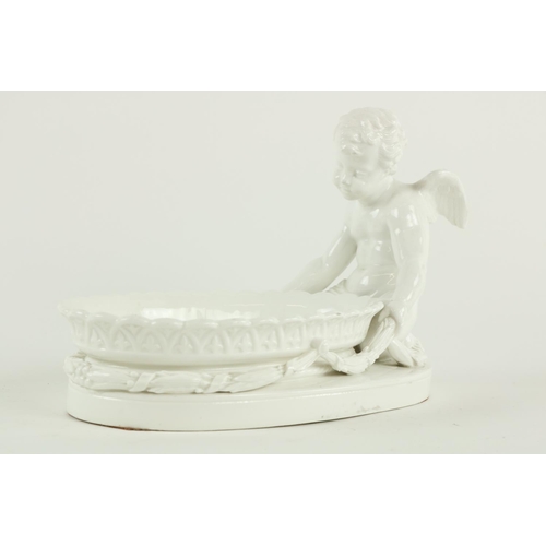 292 - An oval blanc-de-chine cherub Dish, of oval form, the cherub kneeling holding leaf swags around an o... 