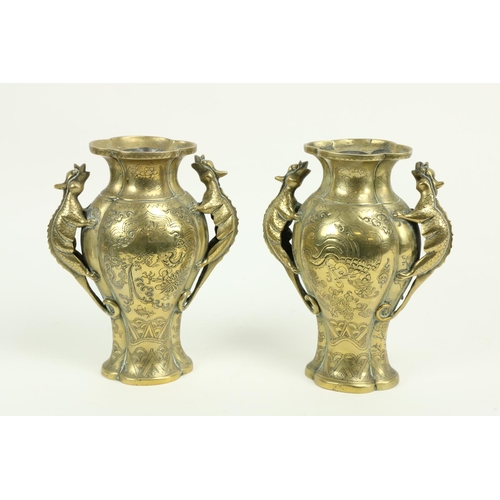 302 - A pair of heavy Chinese brass Vases, each with two dragon handles on flared and lobed foot, 10