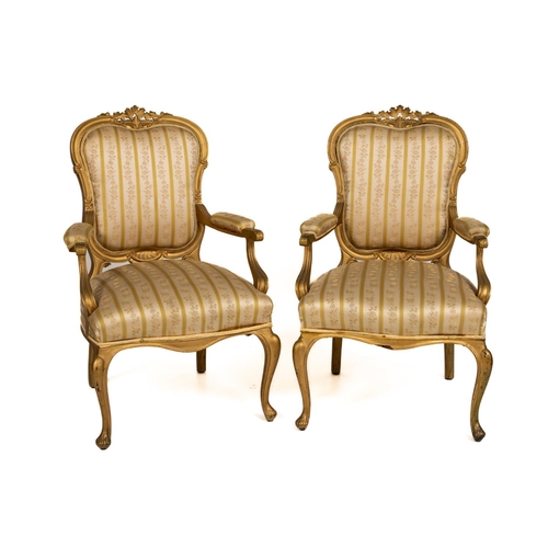 408 - A pair of Louis XV style French giltwood Open Armchairs, with floral crest padded back and arms, on ... 