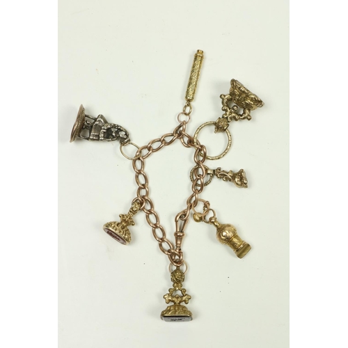 739 - An antique gold oval link Charm Bracelet, with five seals, small Whistle, etc. (a lot)... 