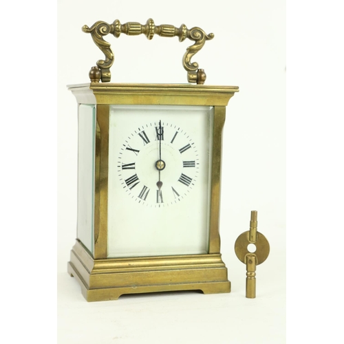 748 - A heavy brass five glass French Carriage Clock, the white dial with Roman numerals and with swing ha... 