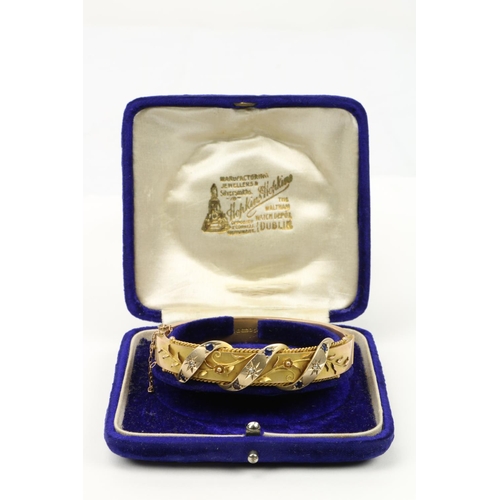 757 - An attractive Edwardian 9ct gold Ladies rigid Bracelet, the interwoven floral design inset with thre... 