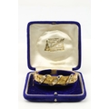 An attractive Edwardian 9ct gold Ladies rigid Bracelet, the interwoven floral design inset with thre... 
