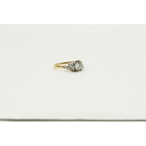 777 - A Ladies 18ct gold Ring Set, with large central diamond flanked to either side with two smaller diam... 